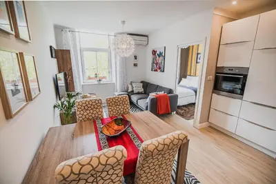 a kitchen and living room with a table and chairs at Apartment Dajana in Bovec