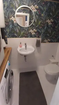 a bathroom with a sink and a toilet and a mirror at Apartment Dajana in Bovec