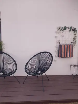 two black chairs sitting on a wooden deck at Apartment Dajana in Bovec