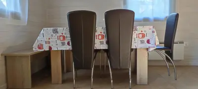two black chairs and a table with a table cloth at Hiška Čatež in Brežice