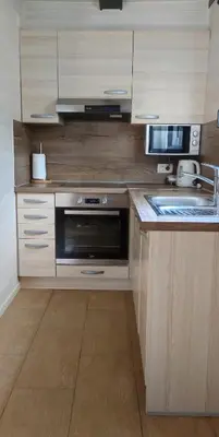a kitchen with a sink and a microwave at Hiška Čatež in Brežice