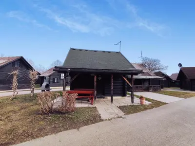 a pavilion with a bench in front of a house at Hiška Čatež in Brežice
