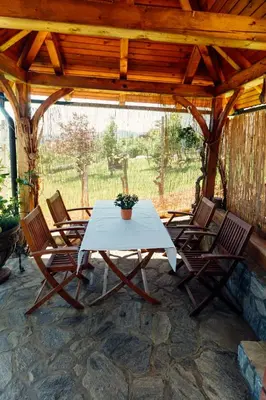 a white table and chairs on a patio at Zidanica Bahor in Črnomelj