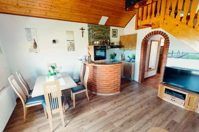 a dining room with a table and a television at Zidanica Bahor in Črnomelj