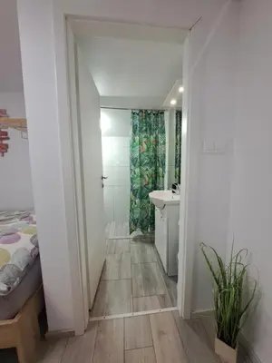 a bathroom with a bed and a sink at Koča Martuljek in Gozd Martuljek