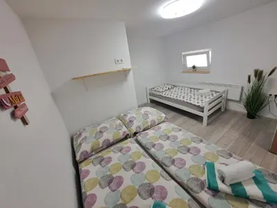 a small room with a bed and a couch at Koča Martuljek in Gozd Martuljek