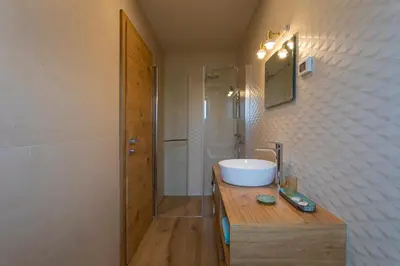 a bathroom with a sink and a shower at Kamp Brda Camping and rooms in Kojsko