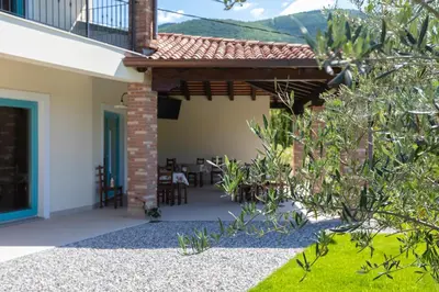 an external view of a house with a patio at Kamp Brda Camping and rooms in Kojsko