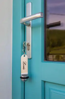 a key tag hanging from a door handle at Kamp Brda Camping and rooms in Kojsko