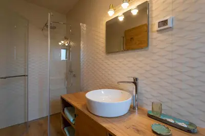 a bathroom with a sink and a shower at Kamp Brda Camping and rooms in Kojsko