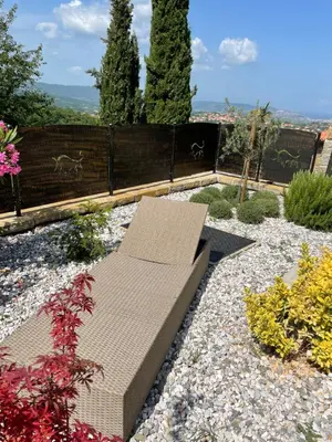 a bench sitting in the middle of a garden at Villa Sanela in Pobegi