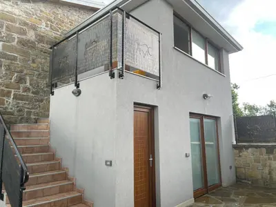 a brick building with a staircase and a door at Villa Sanela in Pobegi