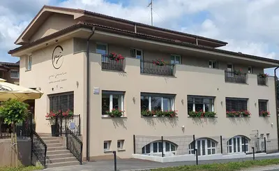 a large building with flower boxes on the windows at Gostilna s prenočišči Pri Janezu in Zgornja Ložnica
