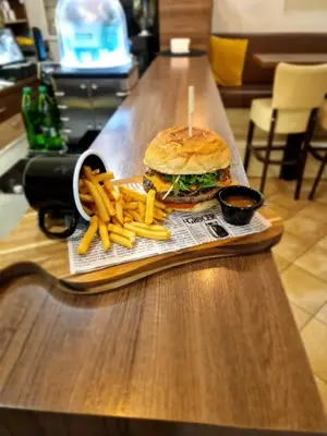 a tray with a sandwich and french fries on a table at Gostilna s prenočišči Pri Janezu in Zgornja Ložnica