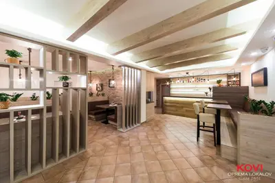 a restaurant with a bar and a dining room at Gostilna s prenočišči Pri Janezu in Zgornja Ložnica