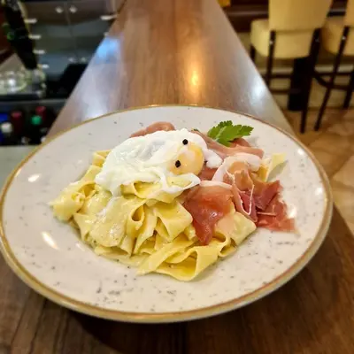 a plate of food with pasta on a table at Gostilna s prenočišči Pri Janezu in Zgornja Ložnica