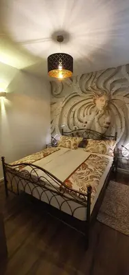 a bedroom with a bed with a wall mural at Apartma Archy in Moravske Toplice