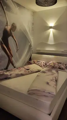a bed with a picture of a surfer on it at Apartma Archy in Moravske Toplice