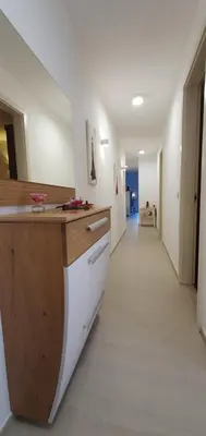 a kitchen with a counter and a long hallway at Apartma Archy in Moravske Toplice