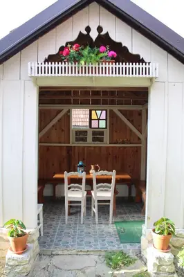 a patio with a table and chairs in a building at Sleeping in Village in Svečina