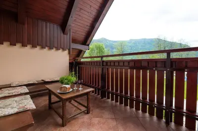 a balcony with a couch and a table at Holiday apartment Pika in Bovec