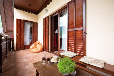 a balcony with a table and glasses of wine at Holiday apartment Pika in Bovec