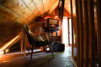a room with a chair and a tv in a attic at HIS-a za 2 in Dragatuš