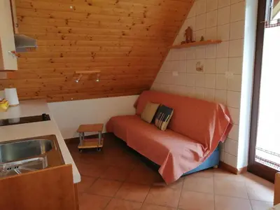 a small room with a bed and a sink at Počitniško stanovanje PLANJA in Soča