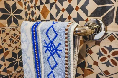 a towel hanging on a towel rack in a bathroom at Sobe - rooms R&K in Bohinj