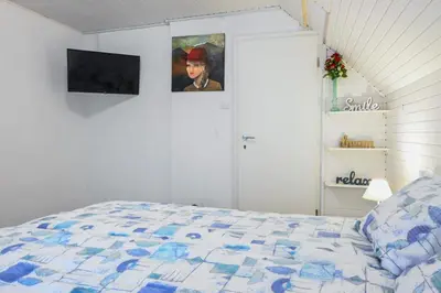 a bedroom with a bed and two pictures on the wall at Sobe - rooms R&K in Bohinj