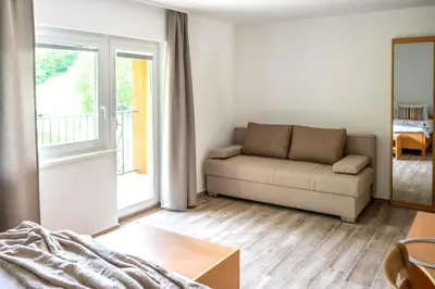 a living room with a couch and a table at Zelena Oaza in Zgornja Kungota