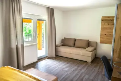 a living room with a couch and a window at Zelena Oaza in Zgornja Kungota
