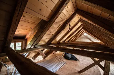 an overhead view of a hammock in a wooden attic at MEŽNARIJA Radovljica in Radovljica