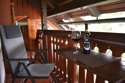 a bottle of wine sitting on a table with a glass at Apartmaji Preželj in Bohinj