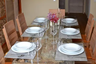 a table with plates and wine glasses on it at Villam Apartment in Maribor
