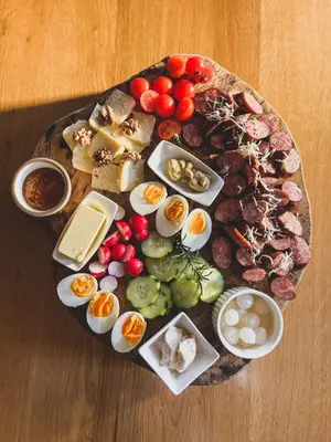 a plate of food with eggs and other foods on a table at Villam Apartment in Maribor
