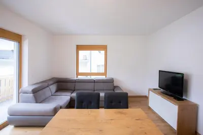 a living room with a couch and a tv at Apartment Bistra Kranjska Gora in Kranjska Gora