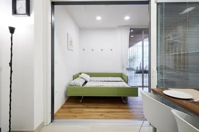 a bedroom with a green bed in a room at Apartments Smreka Kranjska Gora in Kranjska Gora
