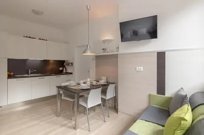 a kitchen and dining room with a table and a couch at Apartments Smreka Kranjska Gora in Kranjska Gora