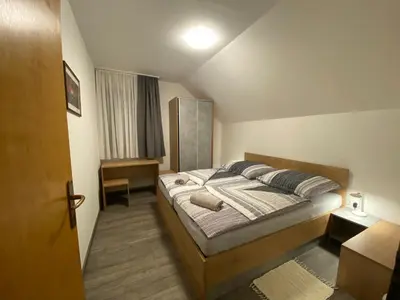 a bedroom with a large bed in a room at APARTMA BRDO BC in Bovec
