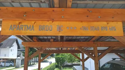 a wooden sign that reads aparna brook bexiaoiaoiaoiao village at APARTMA BRDO BC in Bovec