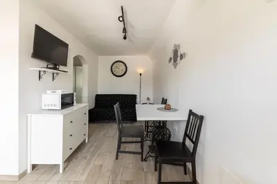 a living room with a white table and chairs at Pod Koblo Bohinj Apartments in Bohinj