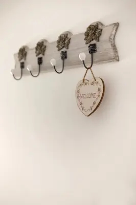 a wooden cross and a heart hanging on a wall at Pod Koblo Bohinj Apartments in Bohinj