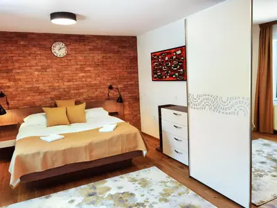 a bedroom with a bed and a brick wall at Hiša Wambrechtsamer - House Wambrechtsamer in Planina pri Sevnici