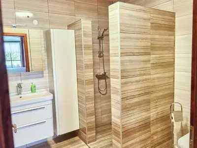 a bathroom with a shower and a sink at Hiša Wambrechtsamer - House Wambrechtsamer in Planina pri Sevnici