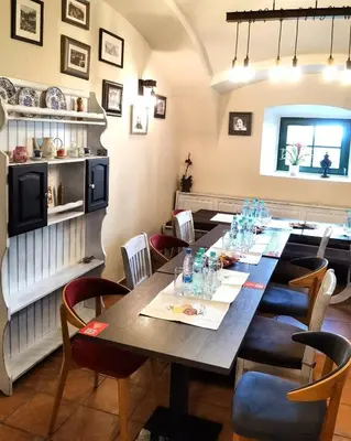 a dining room with a long table and chairs at Hiša Wambrechtsamer - House Wambrechtsamer in Planina pri Sevnici