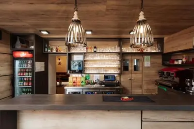 a kitchen with a counter and two pendant lights at Hiša Wambrechtsamer - House Wambrechtsamer in Planina pri Sevnici