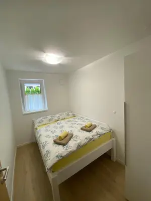 a bedroom with a bed with two shoes on it at Apartma Kati in Bovec