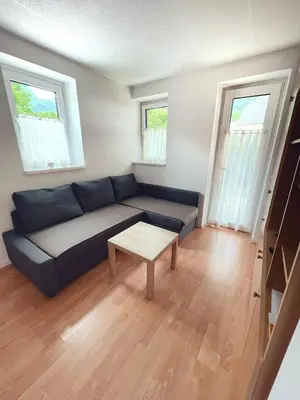 a living room with a couch and a table at Apartma Kati in Bovec