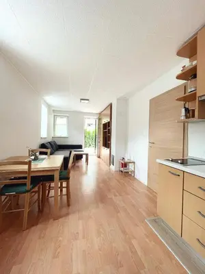 a kitchen and living room with a table and a dining room at Apartma Kati in Bovec